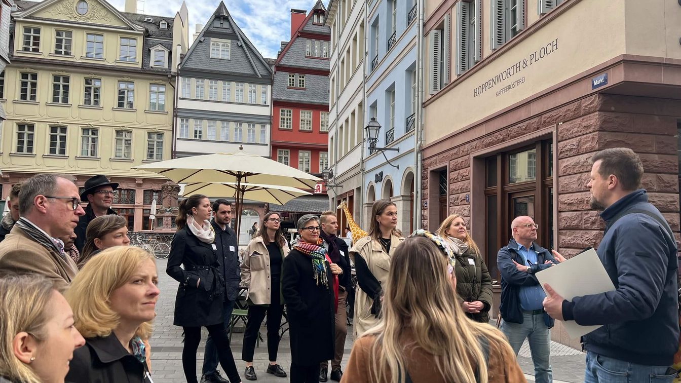 A group of people on a guided tour in Frankfurt's New Old Town.
